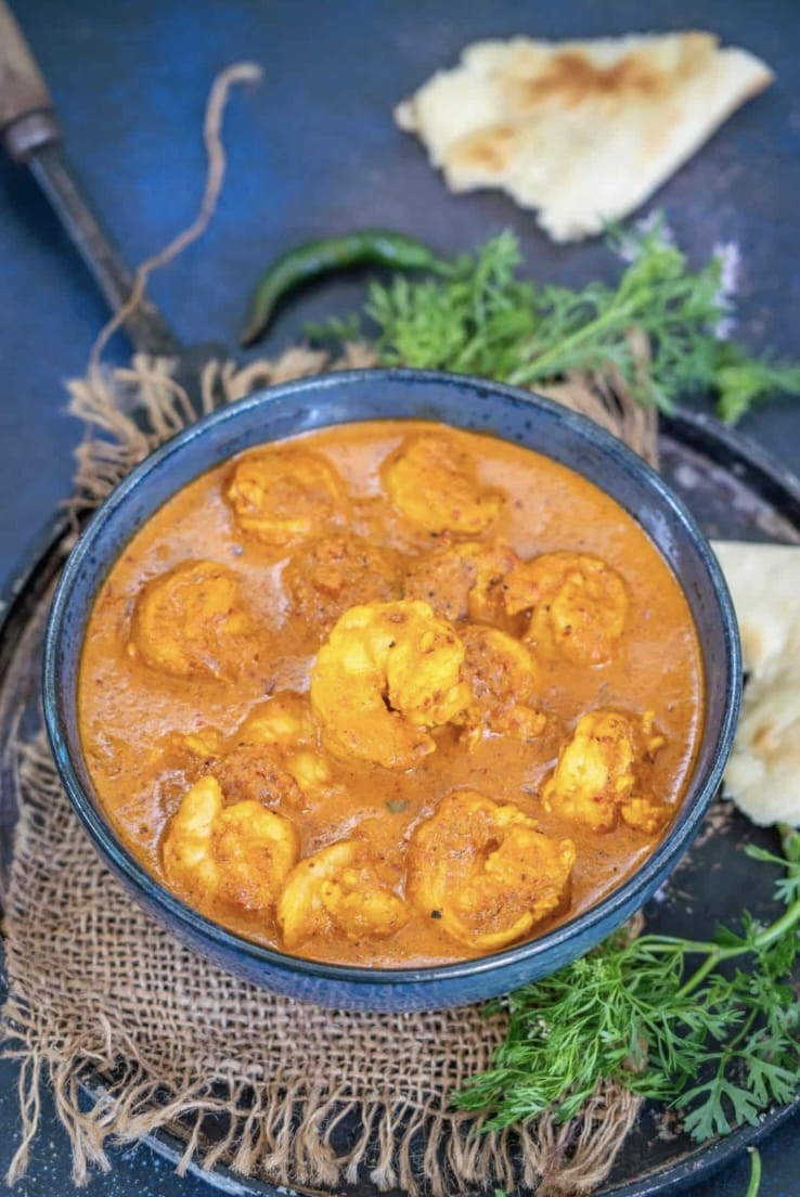 Shrimp curry in a black bowl